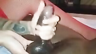 Hot blonde in red lingerie performing a handjob on black cock until he cums